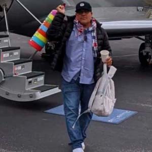 Paint of a woman diving into a swimming pool and a red F1 car in the background